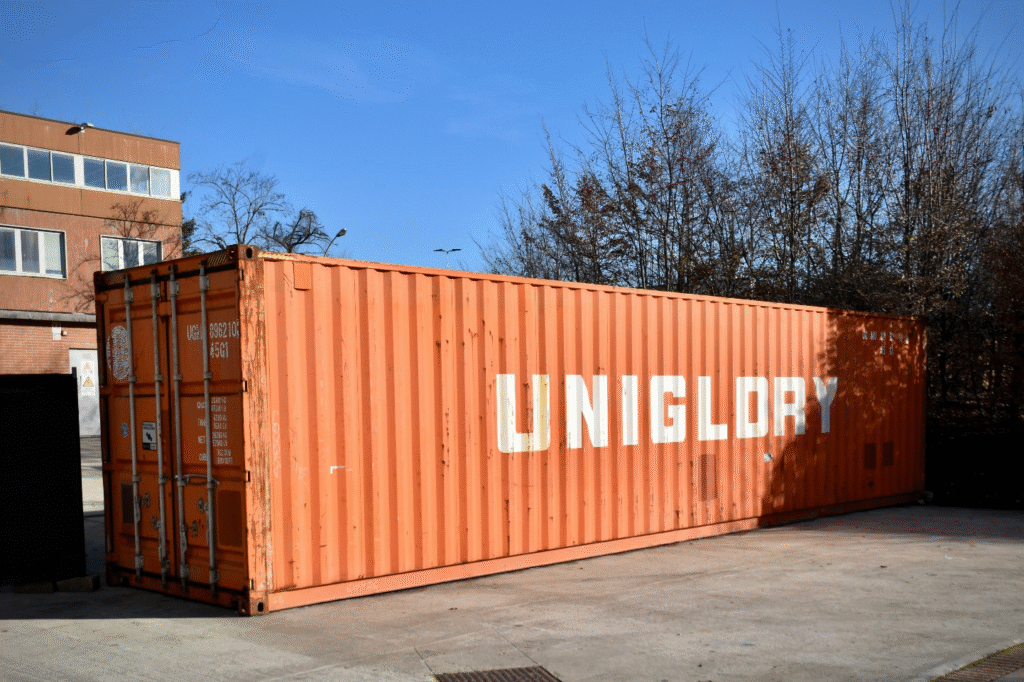 Orange shipping container representing logistics infrastructure in AI fleet management systems