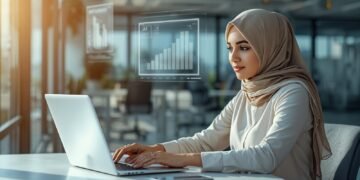 Business professional in a modern U.S. office analyzing AI tools on a laptop with digital analytics dashboard, representing the best AI tools for business in USA.